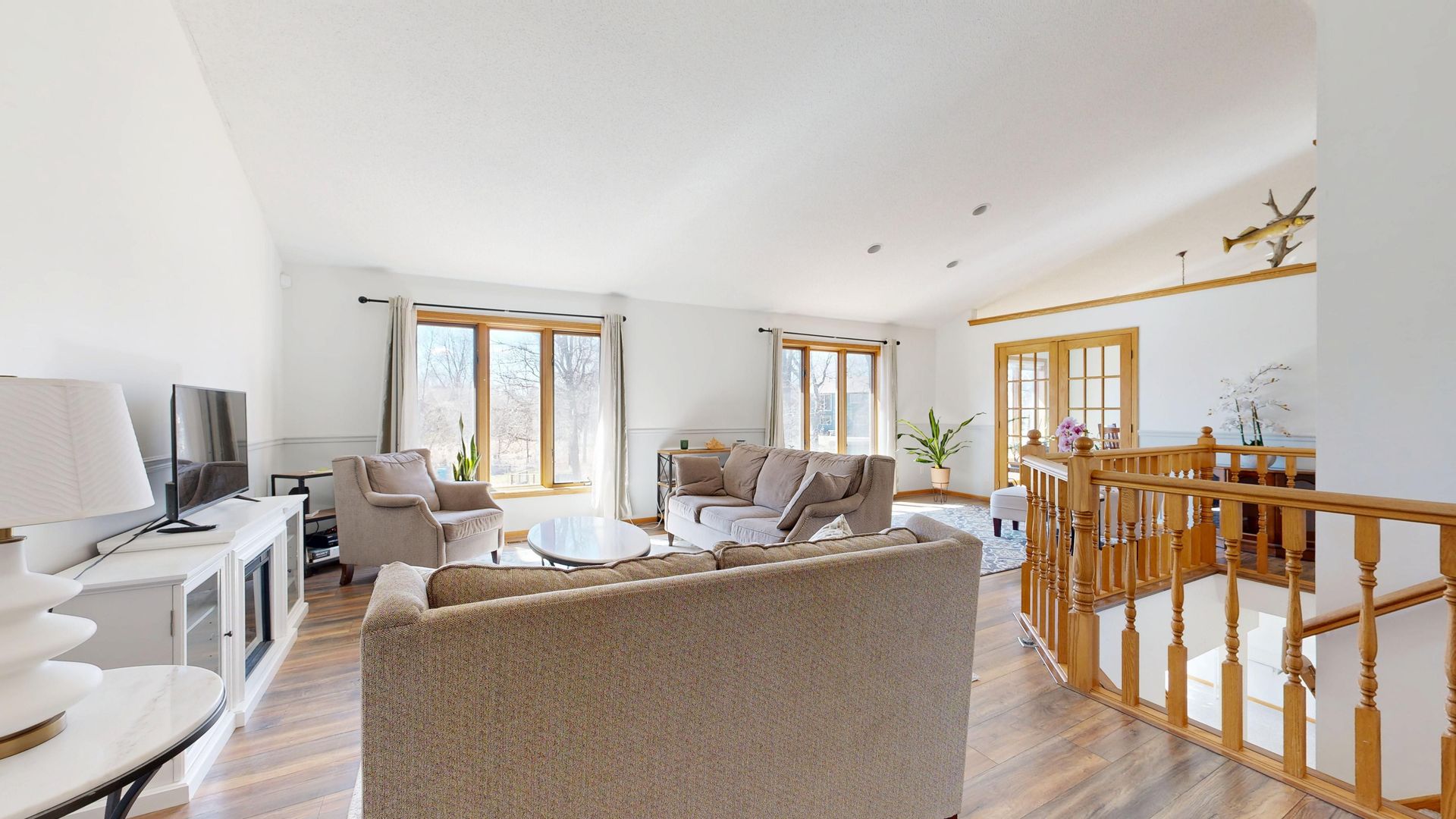 Bright and airy living room featuring neutral furnishings and large windows for natural light.